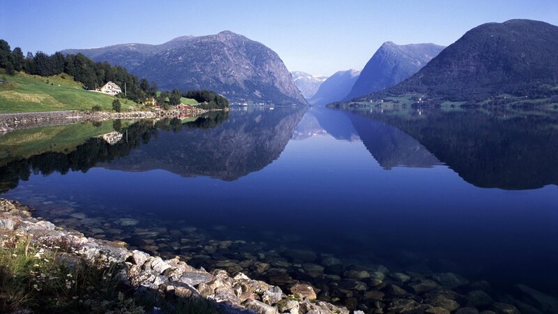 calm fjord with mountain reflections