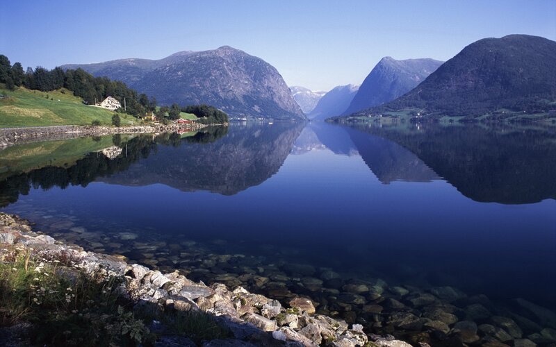 calm fjord with mountain reflections