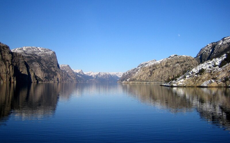 calm fjord with snow-capped mountains