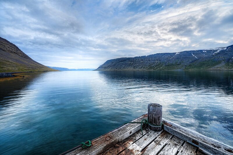 Calm fjord with wooden dock