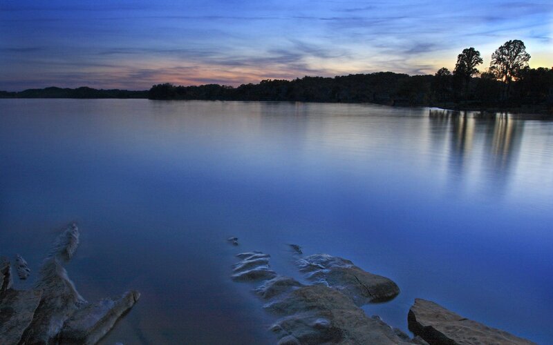Calm Lake at Dusk — Blue, Serene, Sunset, Photograph, Rocks, Trees