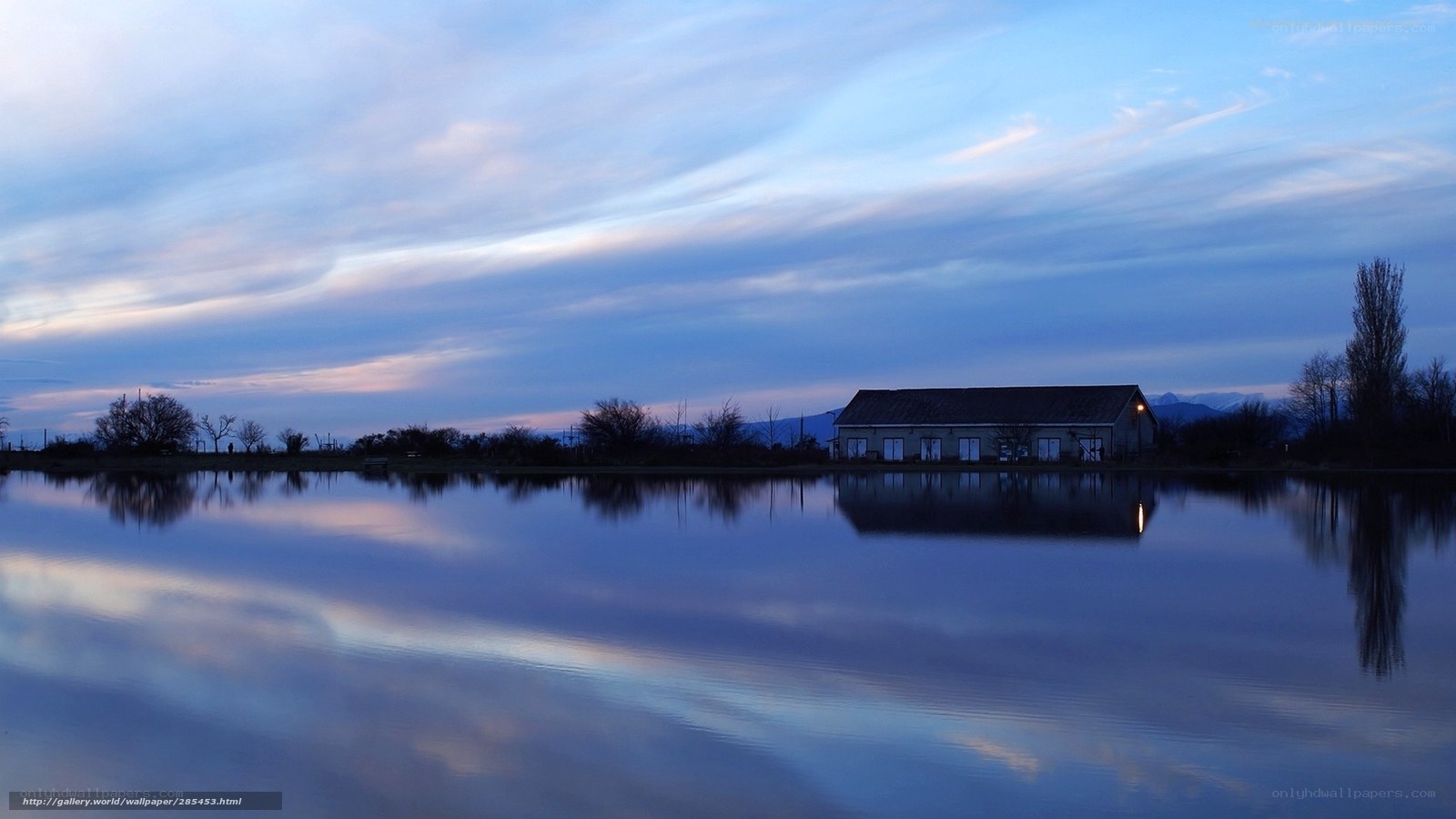 Calm lake at dusk with building