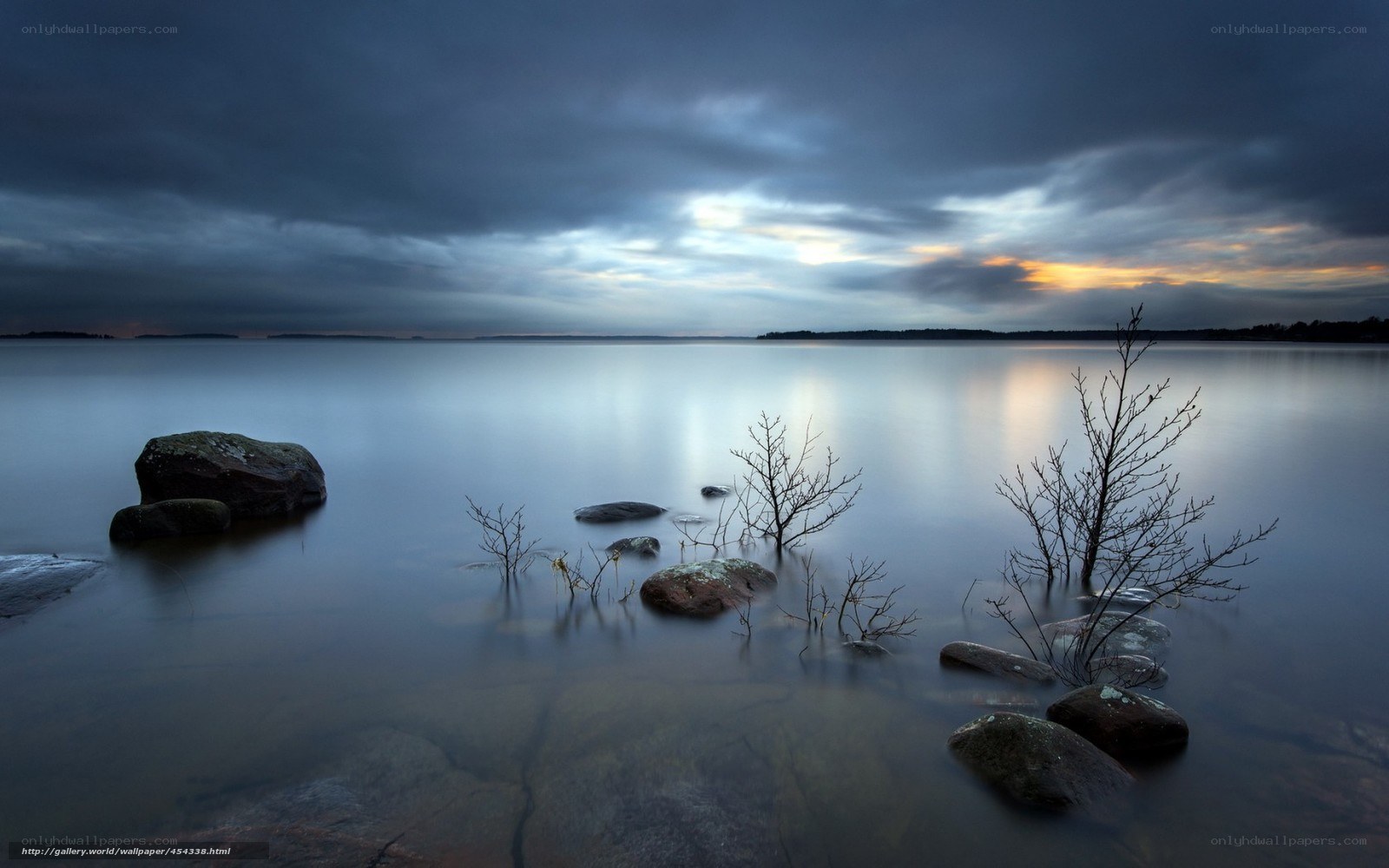 Calm lake at dusk with rocks