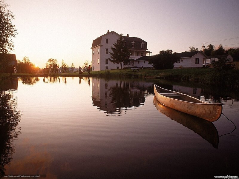 Calm lake at sunset with house
