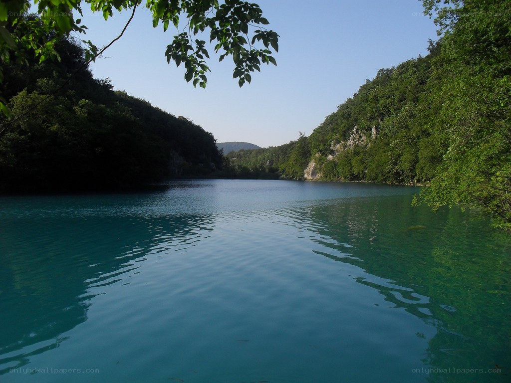 Calm lake in a forested valley