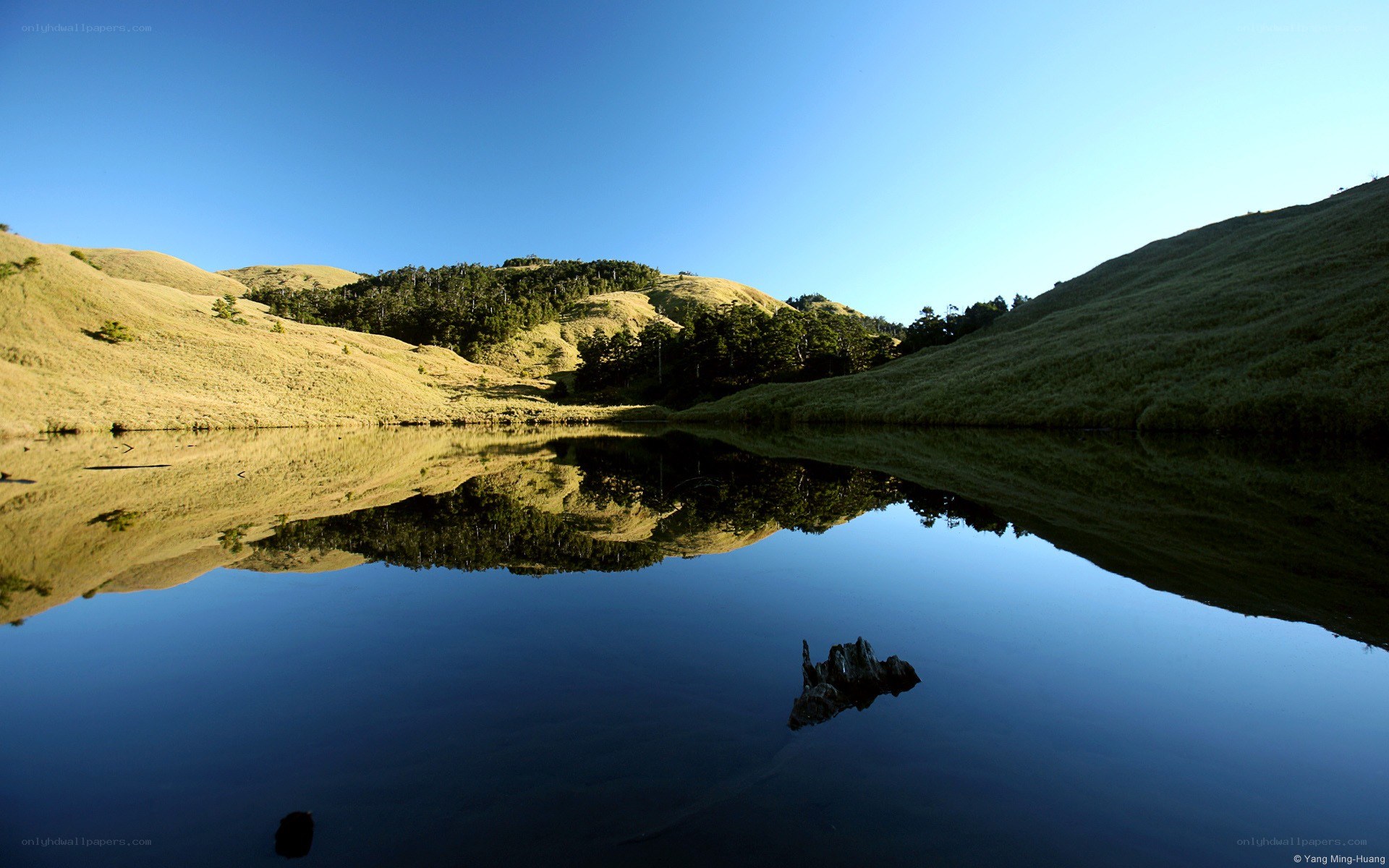 Calm lake reflecting hills