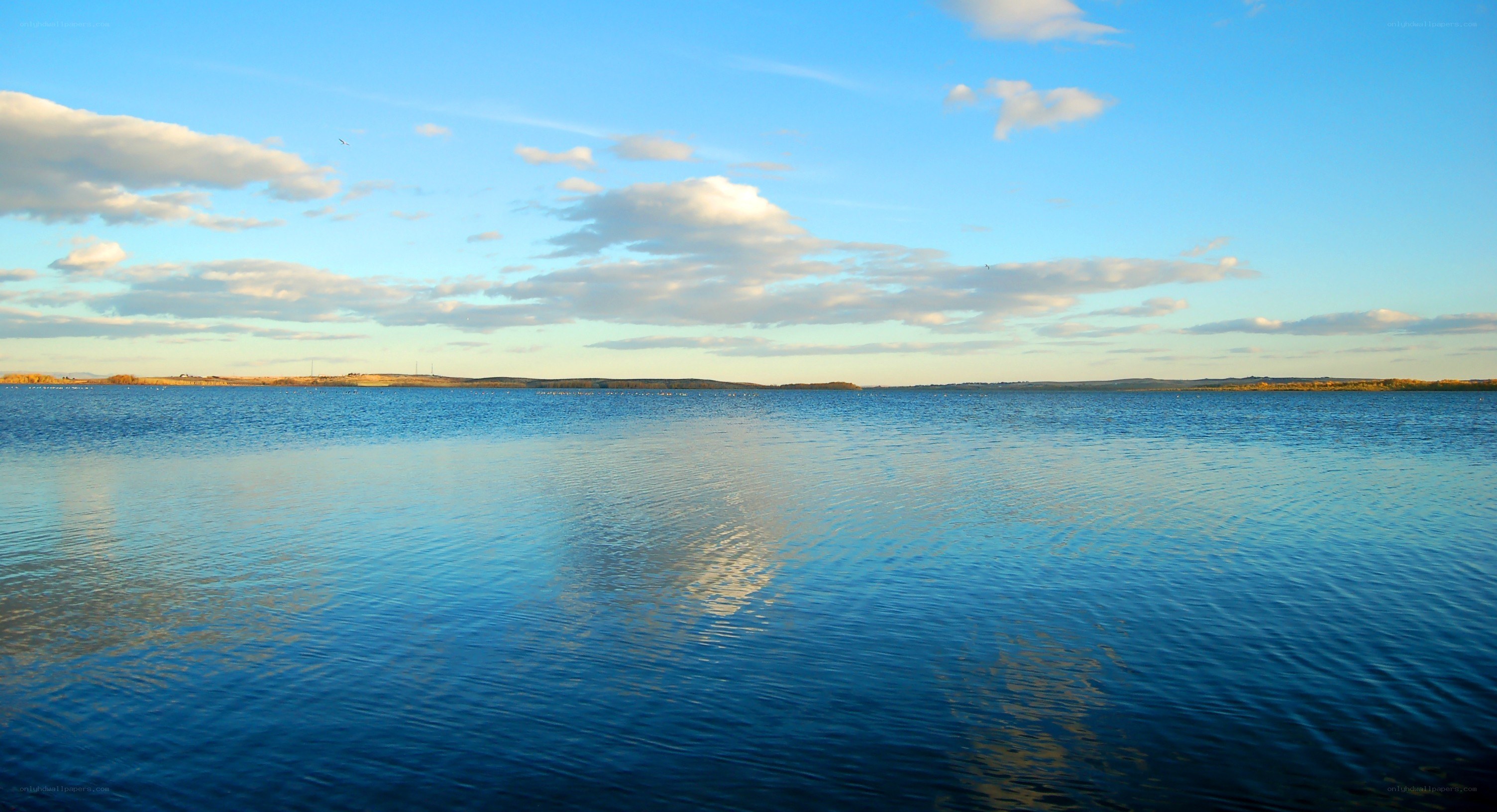 calm lake under blue sky