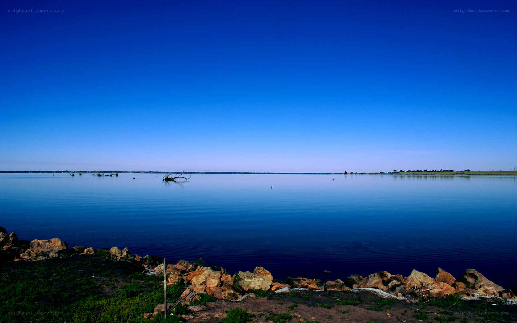 Calm lake under clear sky