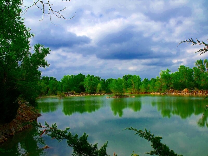 Calm lake under cloudy sky