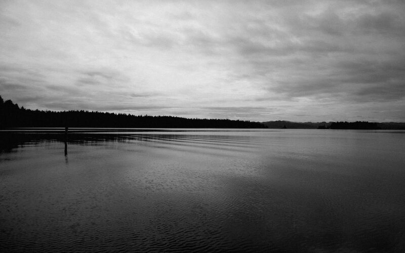 calm lake under cloudy sky