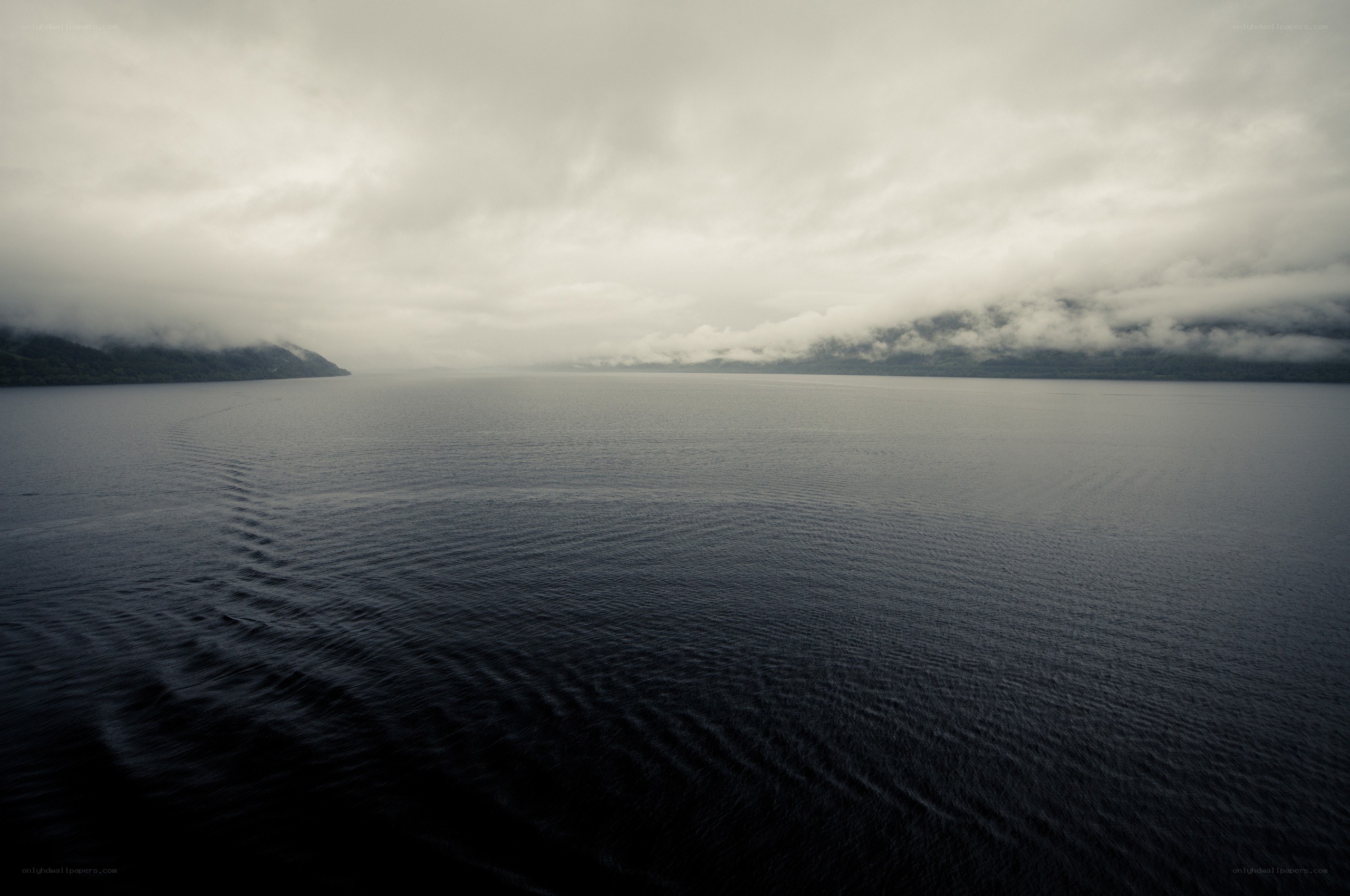 calm lake under cloudy sky