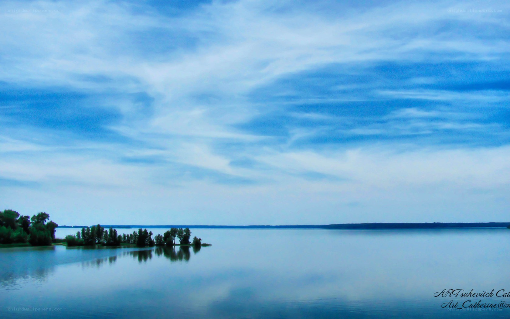 calm lake under cloudy sky