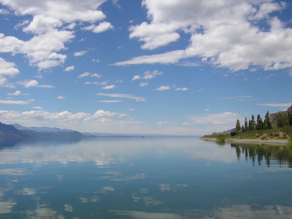 Calm lake under cloudy sky
