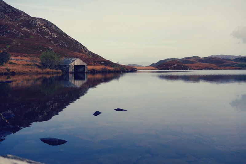 Calm lake with boathouse