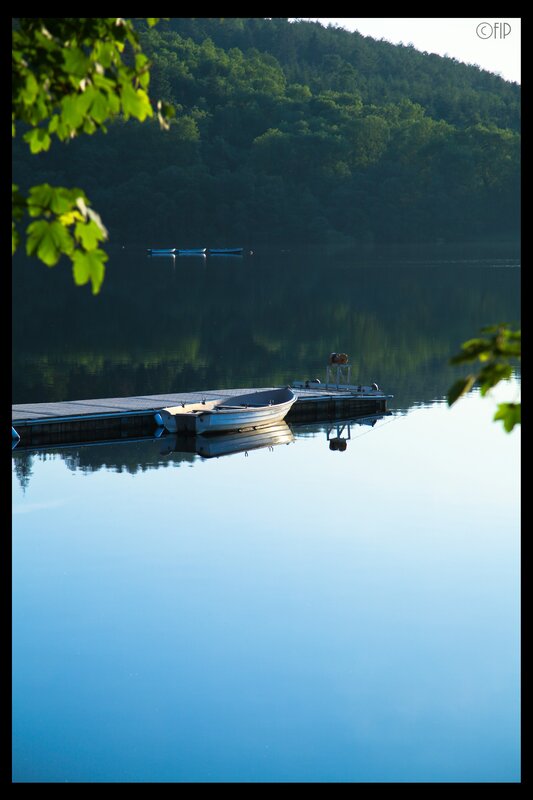 Calm lake with boats and dock