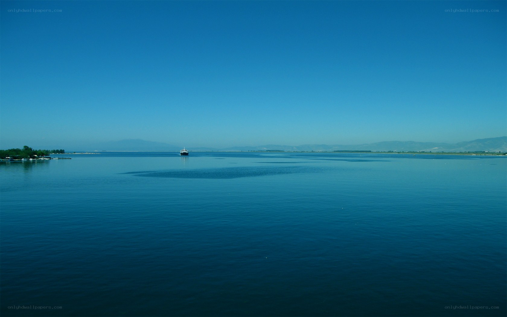 Calm lake with distant boat