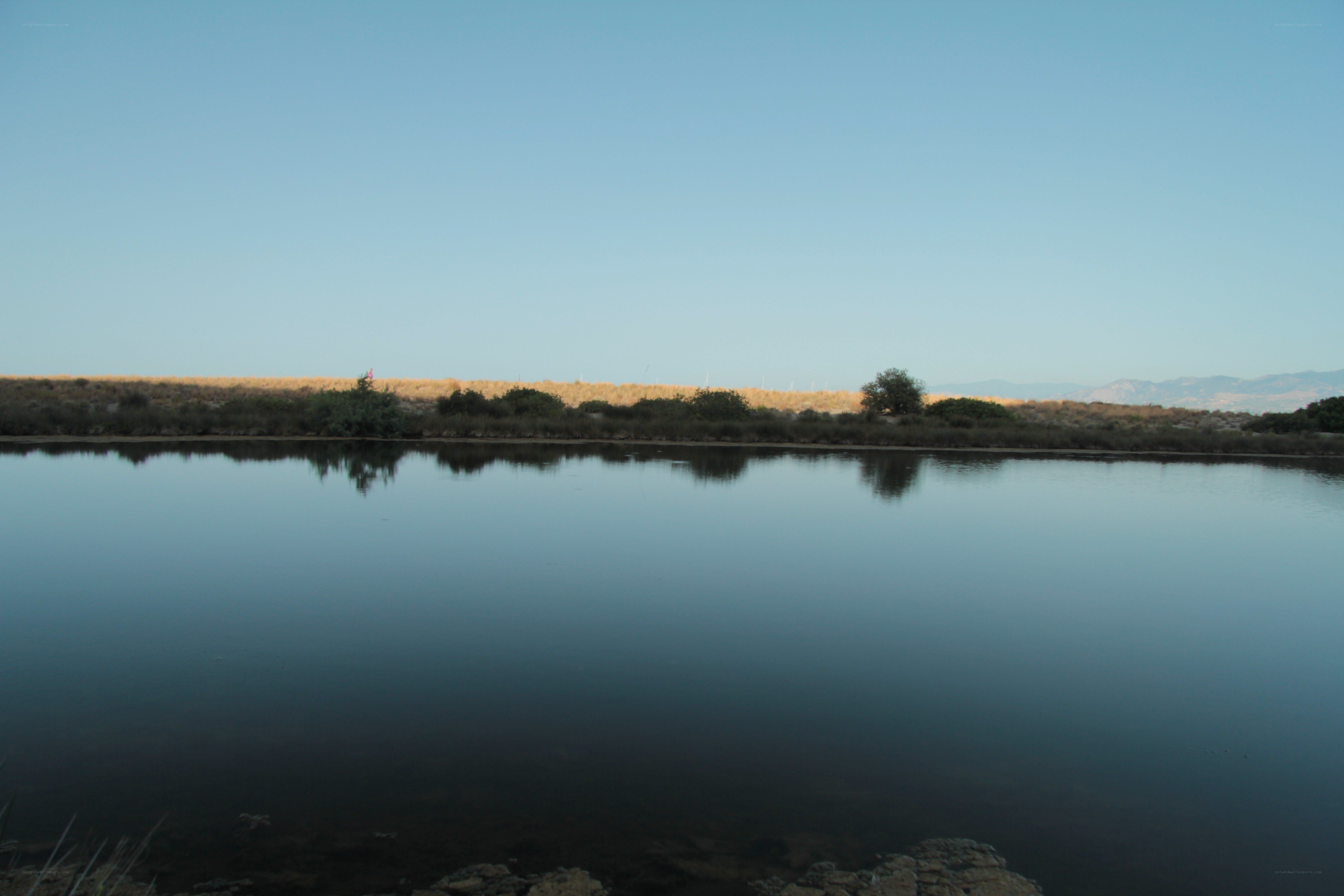 calm lake with distant hills