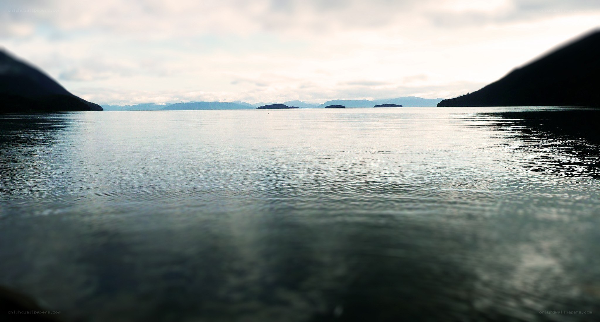 calm lake with distant islands