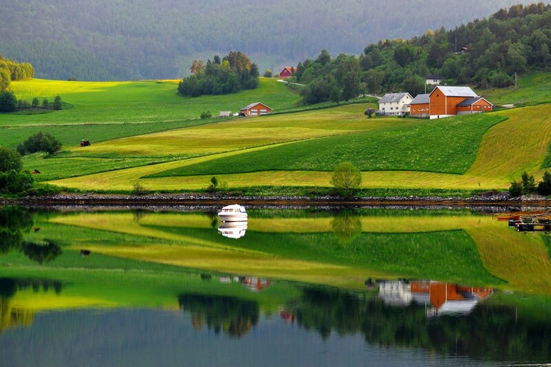 Calm lake with farm houses