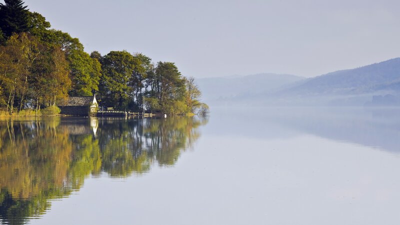 Calm lake with forest reflection