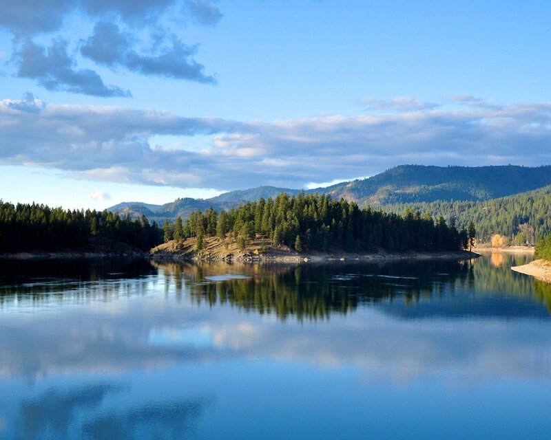 Calm lake with forested hills