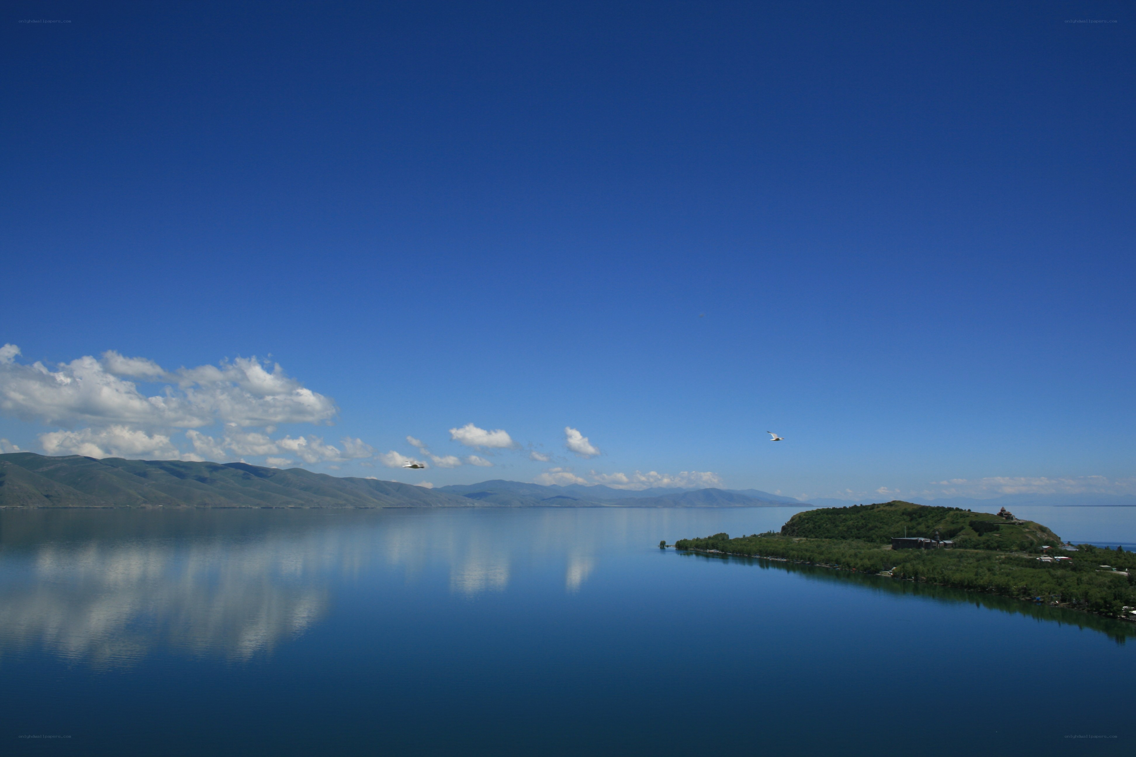 Calm lake with mountains and sky