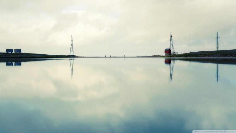 Calm lake with power lines