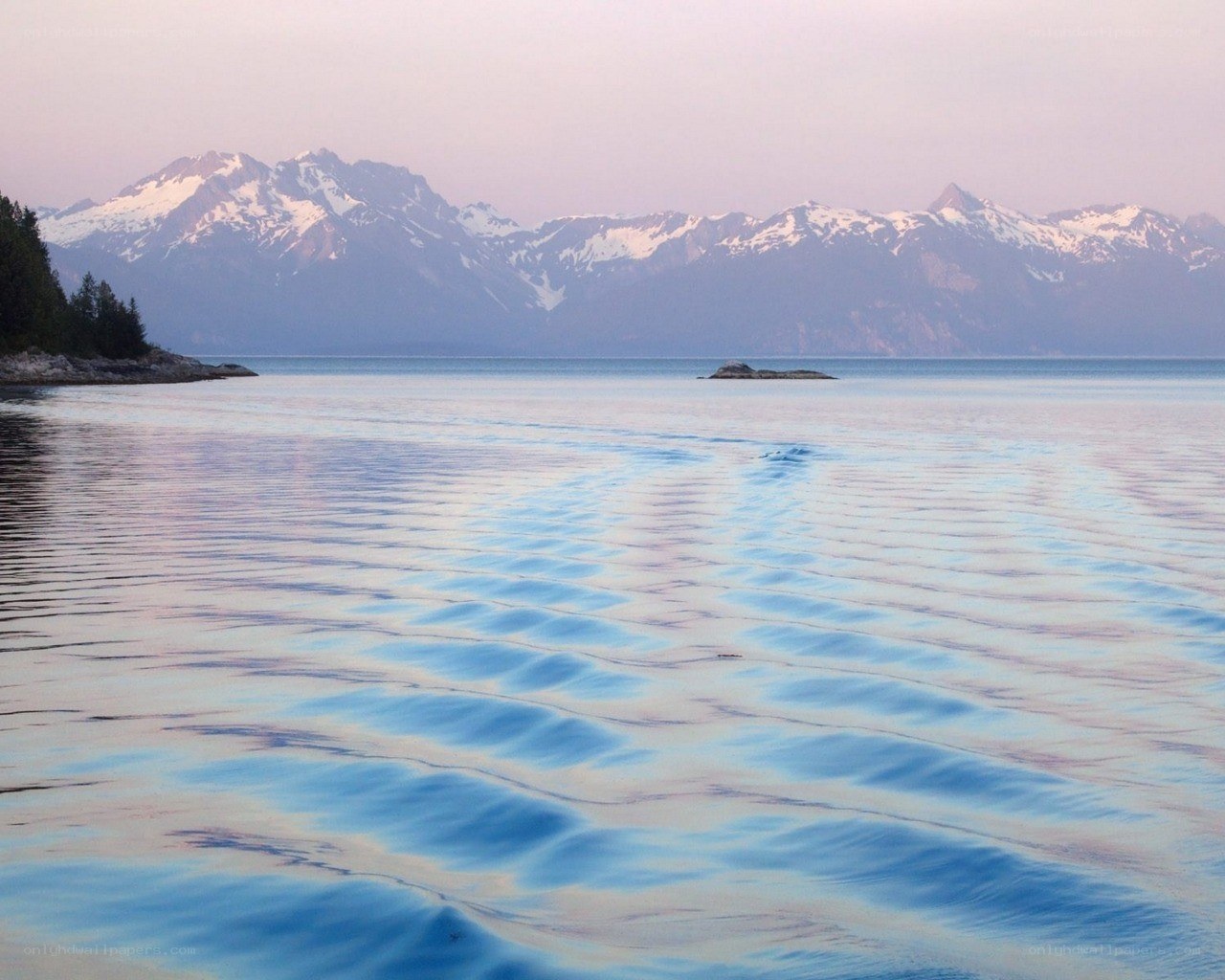 calm lake with snow-capped mountains