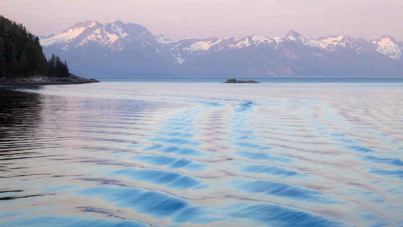 calm lake with snow-capped mountains