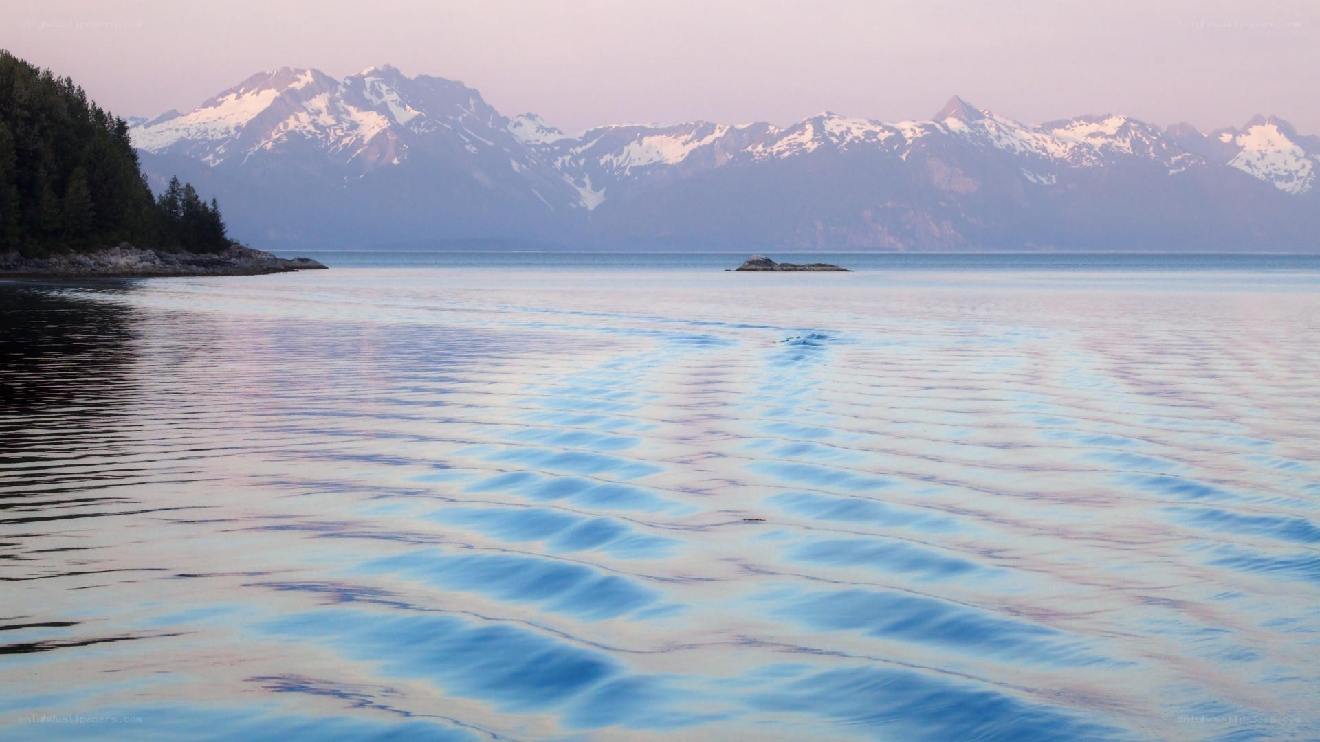 calm lake with snow-capped mountains