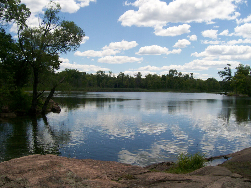 Calm lake with trees and clouds