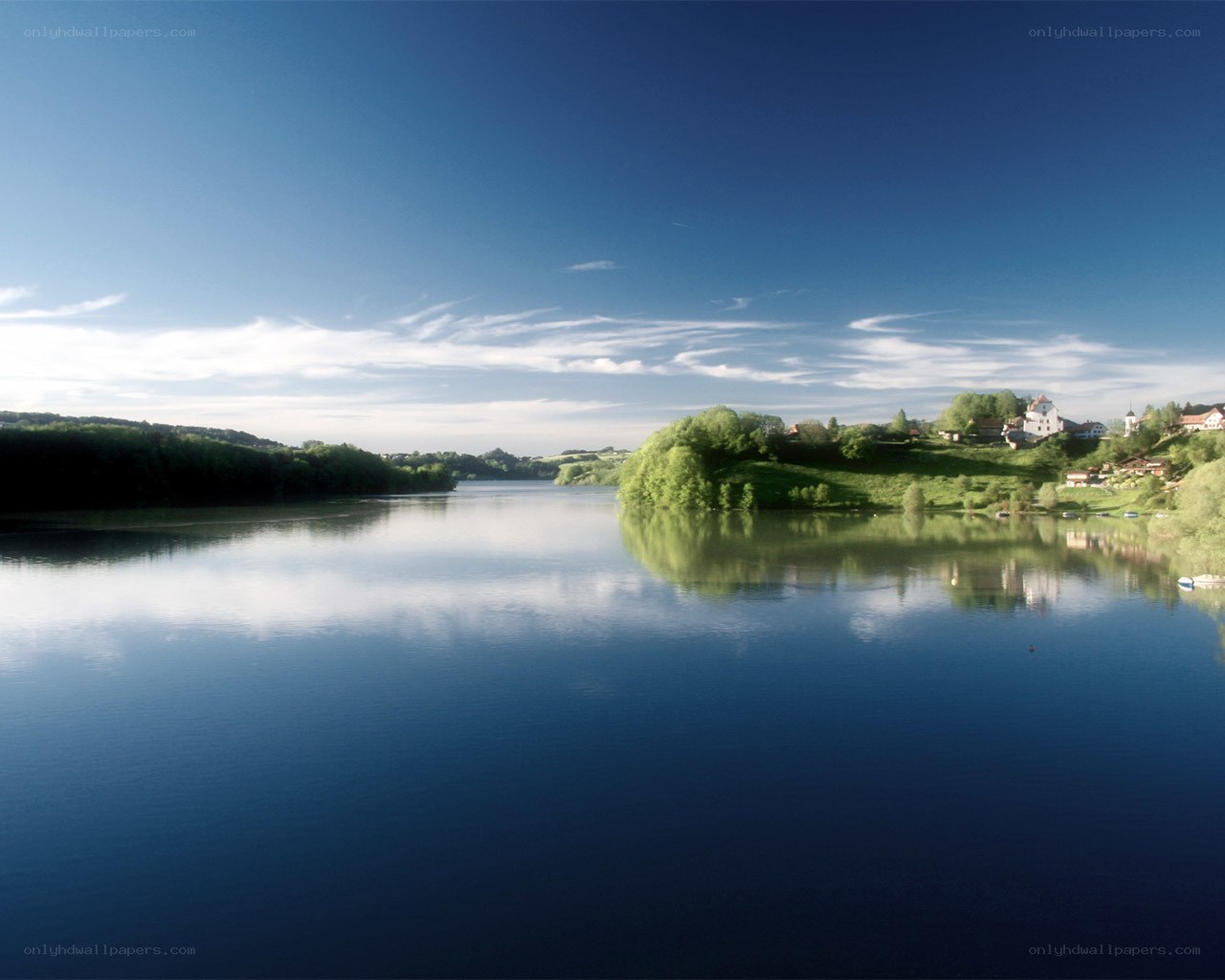 Calm lake with village reflection