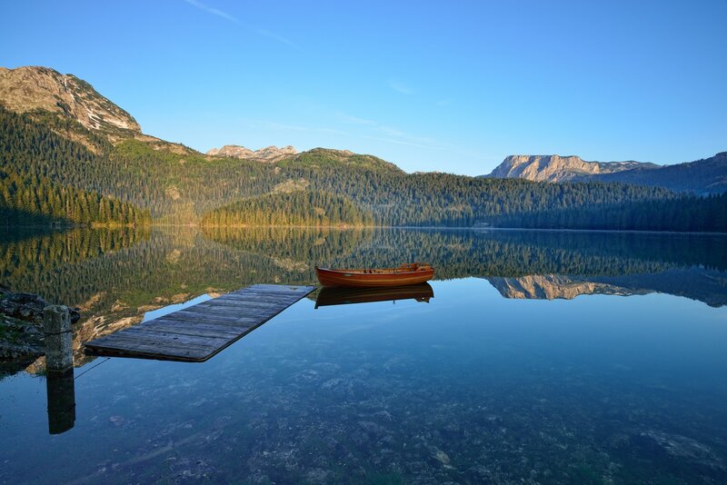 Calm lake with wooden boat