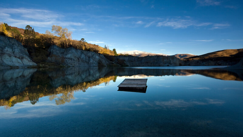 Calm lake with wooden dock