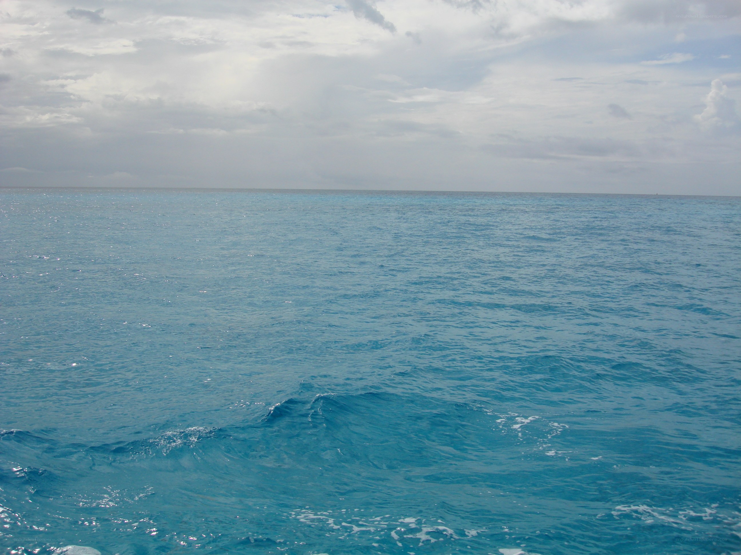 calm ocean under cloudy sky
