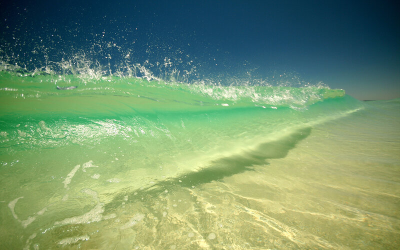 Calm ocean wave at sunset