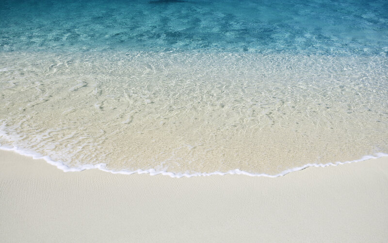 Calm ocean waves on sandy beach