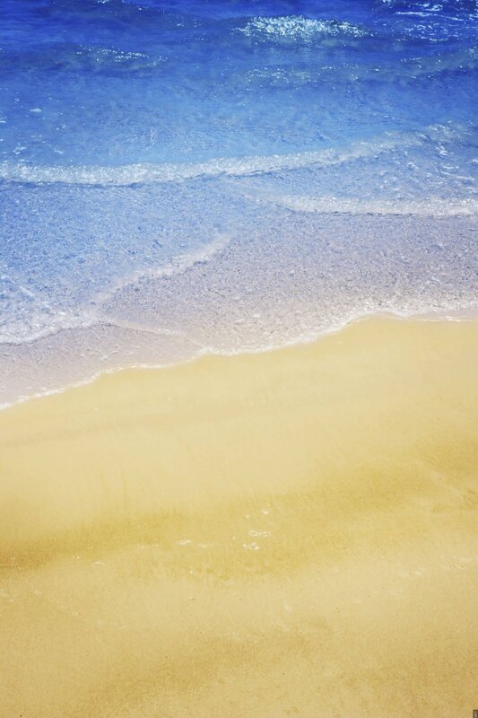 Calm ocean waves on sandy beach