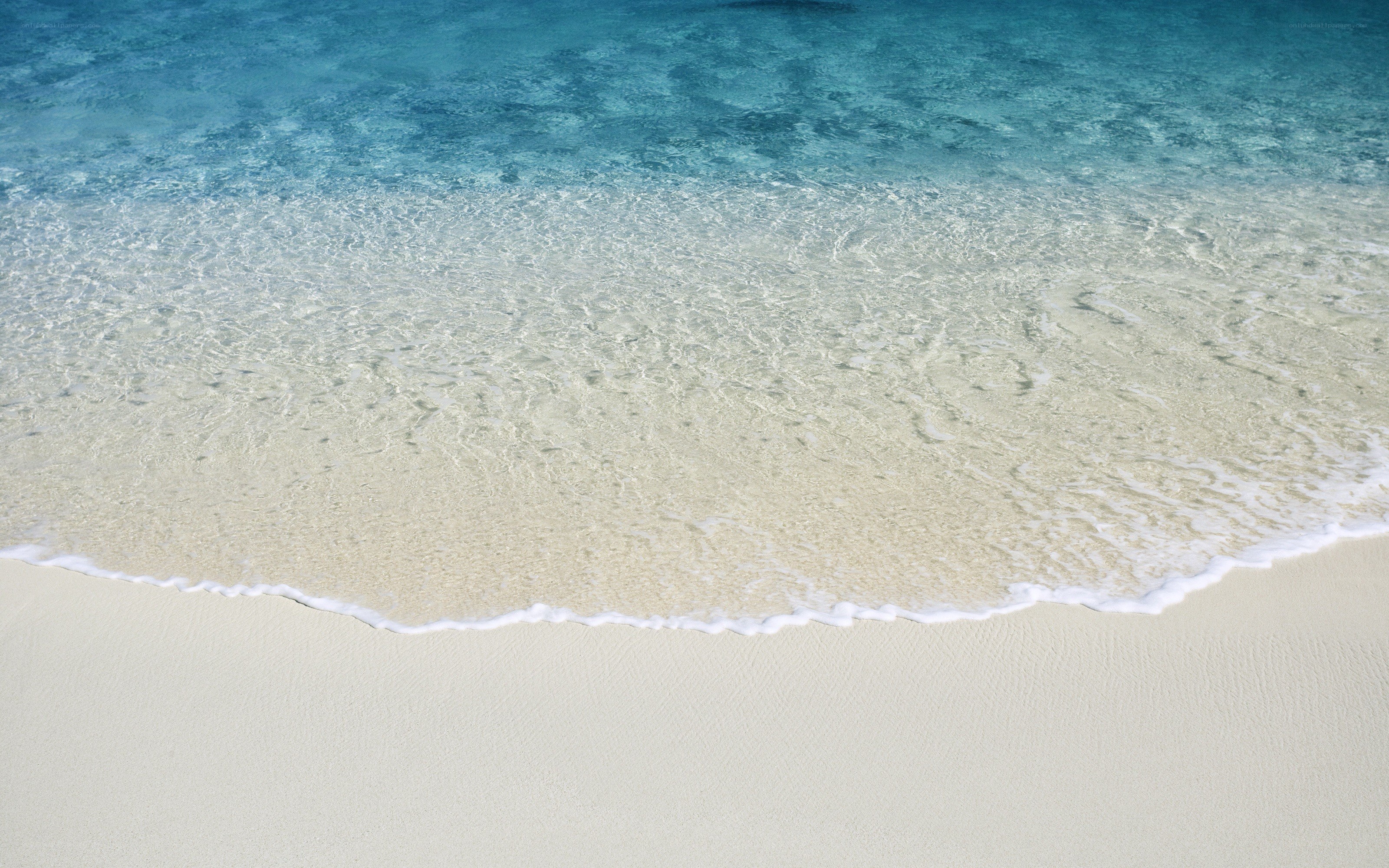Calm ocean waves on sandy beach