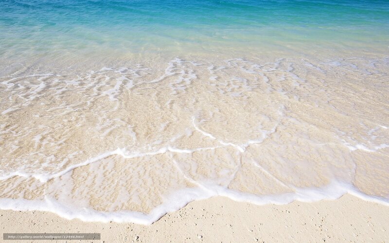 Calm ocean waves on sandy beach