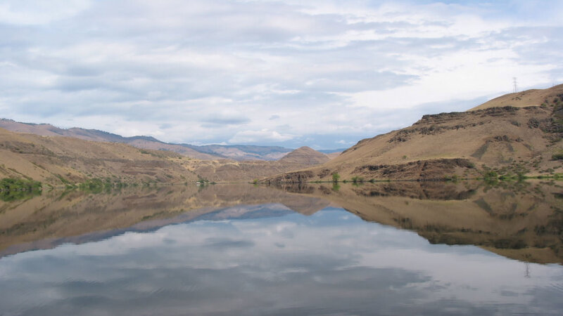 calm river reflecting hills