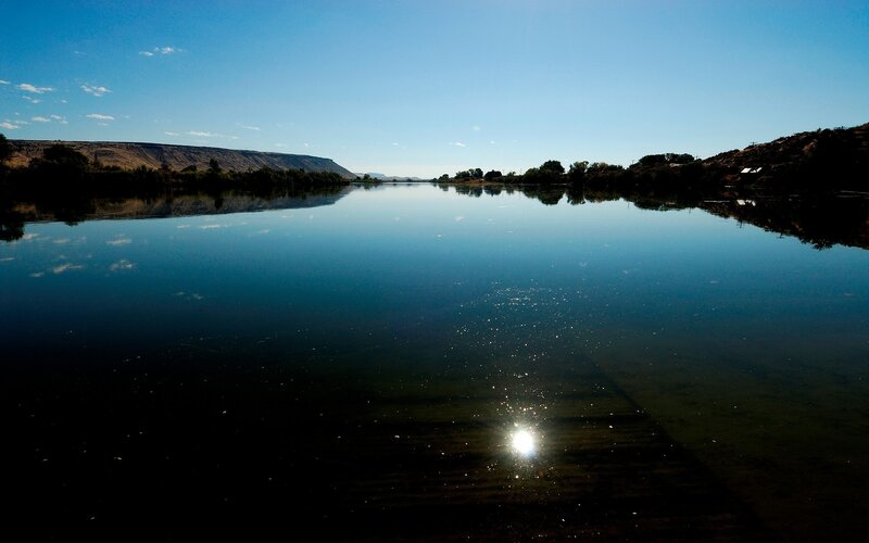 calm river under blue sky