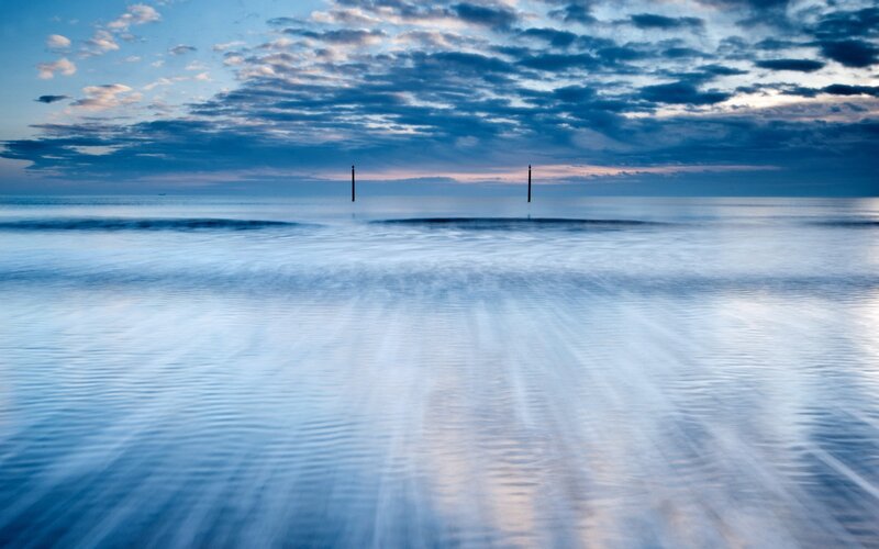 calm sea at dawn with clouds