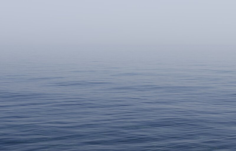 calm sea under overcast sky