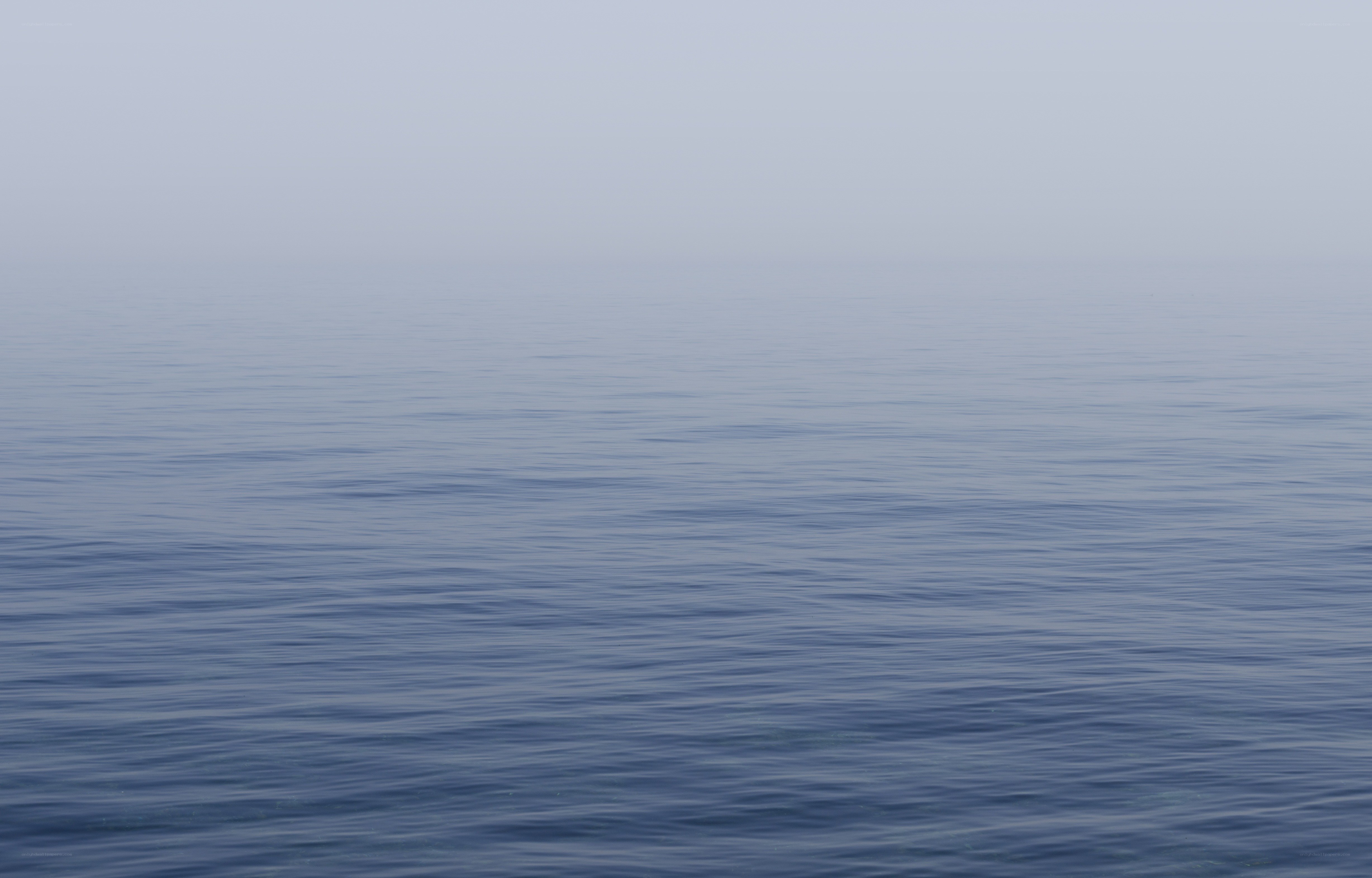 calm sea under overcast sky