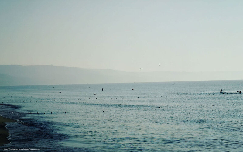 calm sea with distant hills