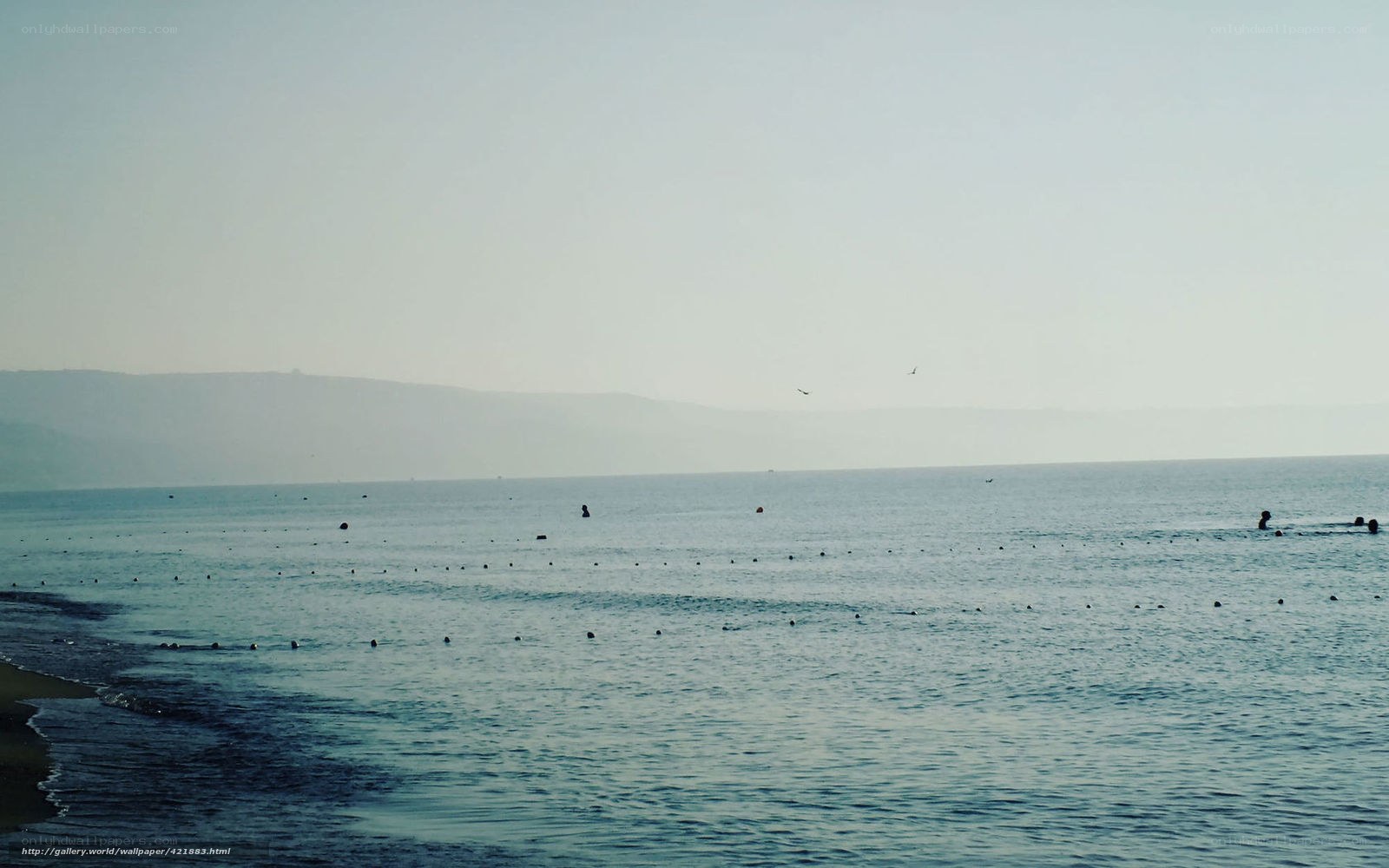 calm sea with distant hills