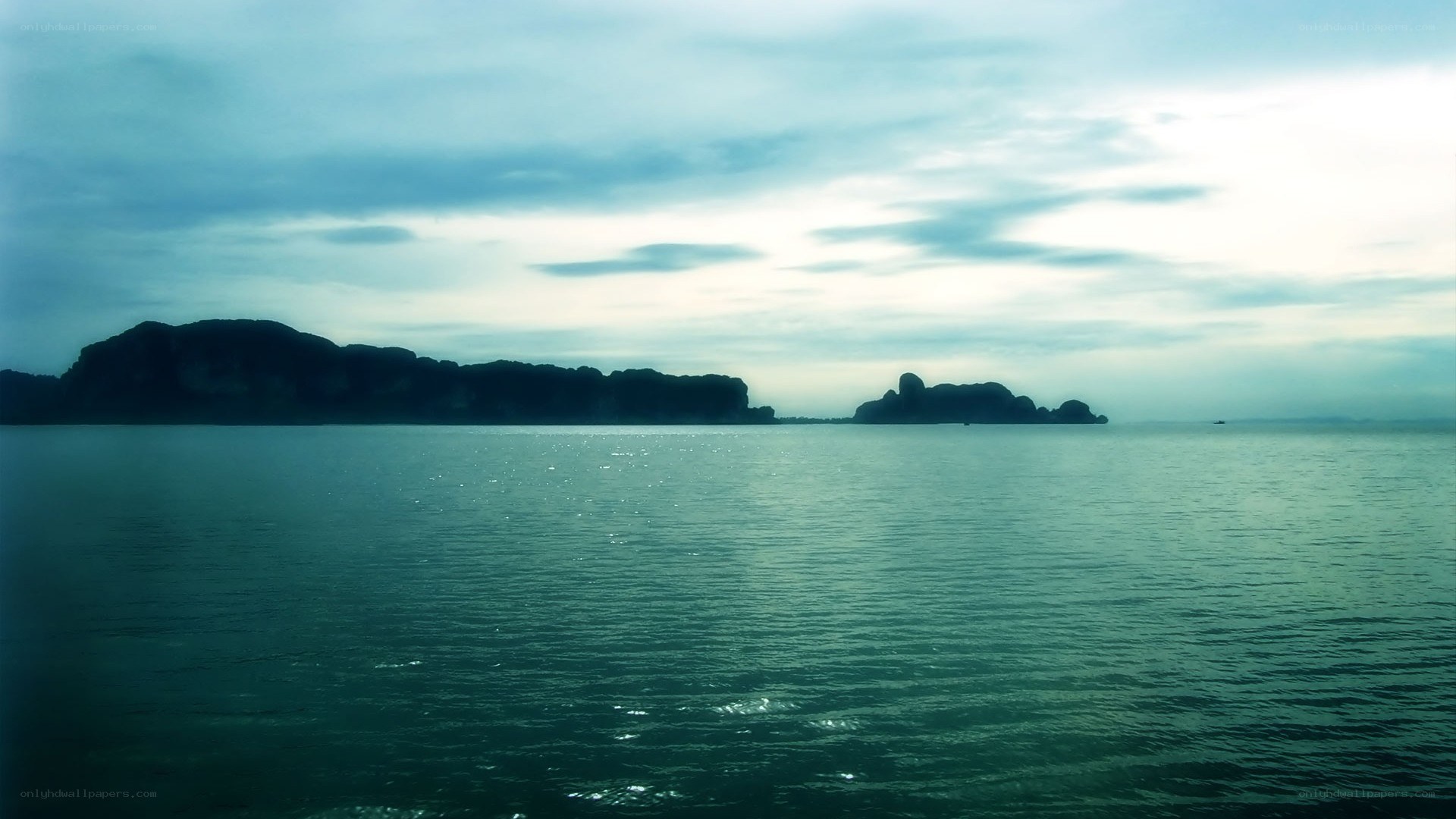 calm sea with distant islands
