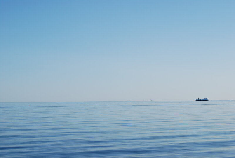 calm sea with distant ships