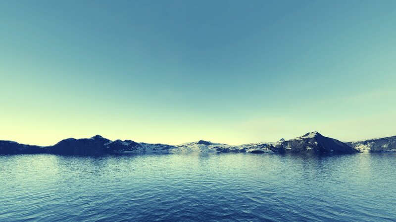 calm sea with snowy mountains